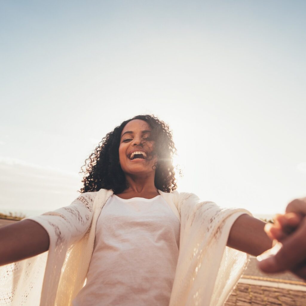 Happy woman after receiving mental health care through telepsychiatry in Flagstaff, Arizona