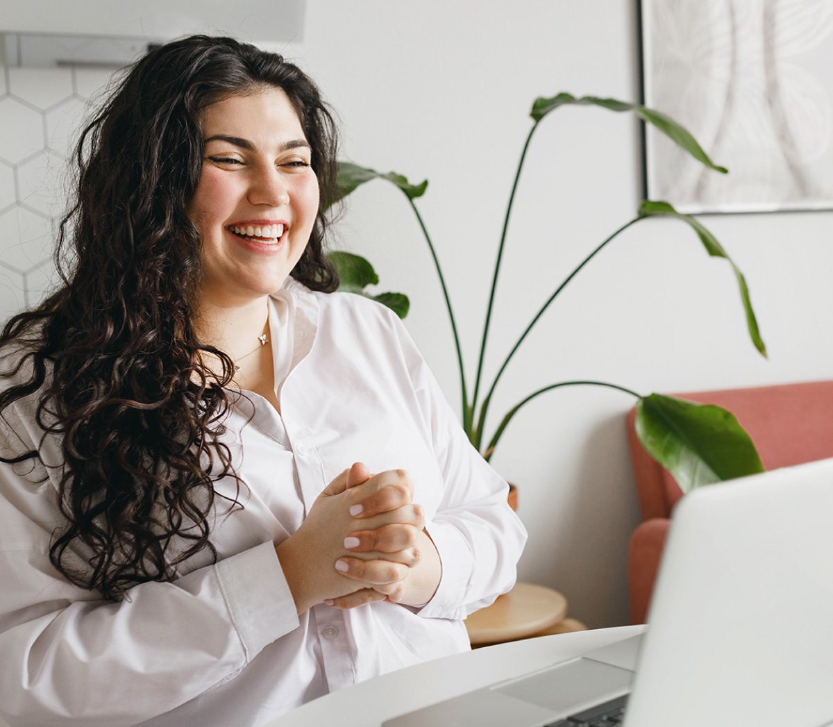 Woman looking at laptop smiling